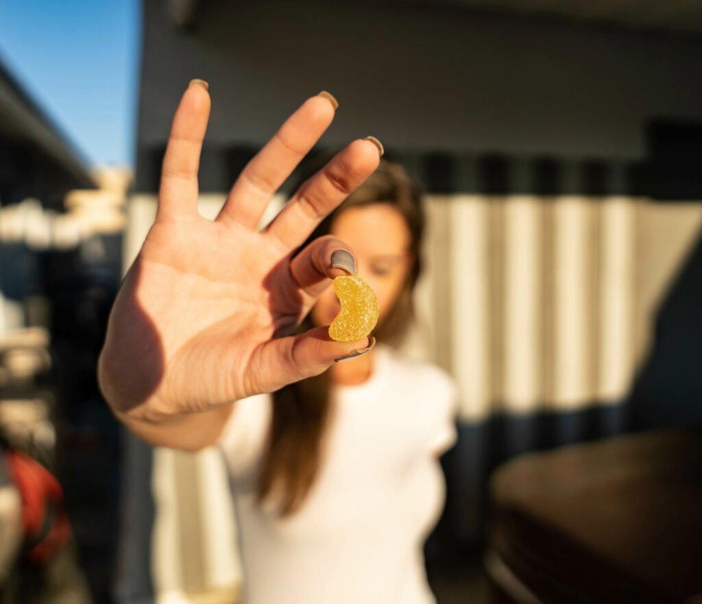 woman holding cbd gummy